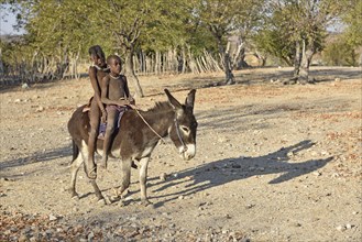 Himbakinder ride on donkey