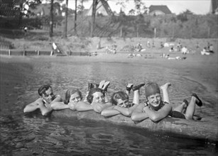 Four Women and a Man in a Swimming Pool