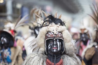 Carnivalists in costume with feathers