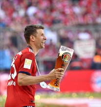Thomas Muller FC Bayern Munich with Paulaner wheat beer for beer shower