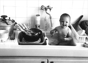 Baby plays in the sink