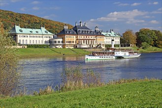 Pillnitz Castle on the banks of the Elbe River with historical paddle steamer