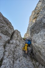 Hiker climbing in the Santner via ferrata