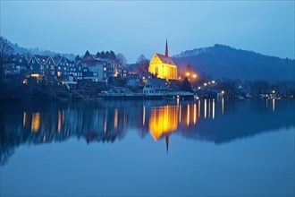 Beyenburg reservoir with the illuminated church of St. Mary Magdalene in the evening