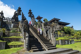 Balinese believers walk down stairs