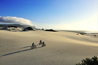 Mountain biking on fat bikes through dunes