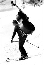Man is skiing with bass ca. 1970s