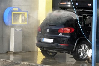 Cleaning car with water pressure hose