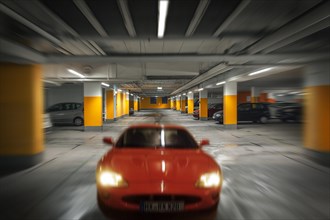 Car drives in underground garage