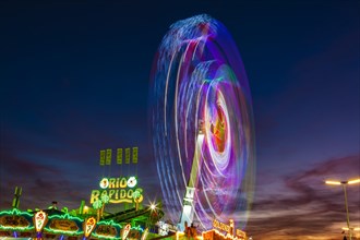 Ride Chaos Pendulum in motion at night