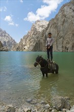 Kyrgyz showing his agility on his horse in Kol-Suu lake
