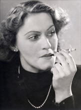 Portrait of a smoking woman with cigarette holder