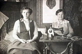 Two women work on the sewing machine
