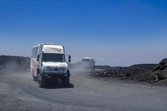 Four-wheel drive vehicles on gravel road to Etna volcano
