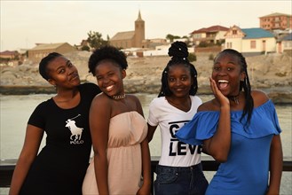 Four young black women posing at the Waterfront