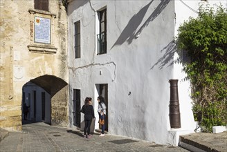 Two young women chatting at the Segur Gate in the hill-top town of Vejer de la Frontera