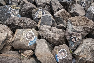 Painted portraits of famous musicians on stones