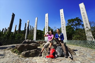 Hikers rest in front of wooden steles at Wisdom Path