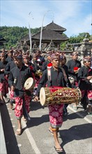 Procession of devout Buddhists with Gamealan musicians at the water temple Pura Ulun Danu Bratan