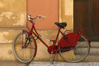 Red bicycle with padlock