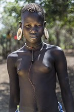 Young girl with ornamental scars on her body