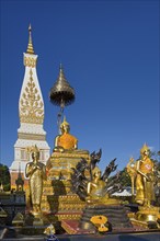 Golden Buddha statues in front of the Chedi of Wat Phra That Phanom