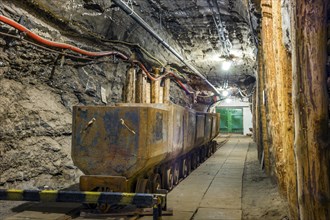 Industrial metal wagon in underground tunnel of salt mine