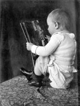 Baby reads magazine and sits on the pot ca. 1930