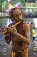 Sadhu plays the flute