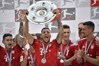 Cheering Corentin Tolisso FC Bayern Munich after handing over the championship cup