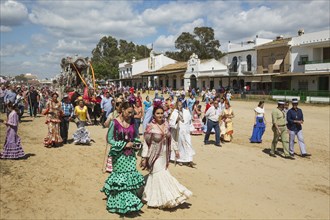 People in traditional clothes and decorated oxcarts