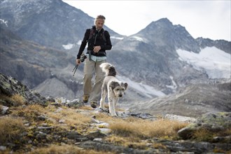 A hiker and his dog in the Hohe Tauern National Park
