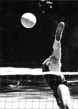 Balancing act at volleyball ca. 1970s