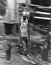 Boy hangs on wire rope