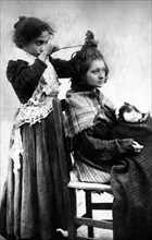 Girl hairdressing her girlfriend