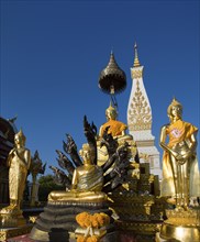 Golden Buddha statues in front of the Chedi of Wat Phra That Phanom