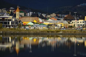 Ushuaia in the evening light is reflected in the Beagle Channel