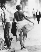 Woman with blown up skirt