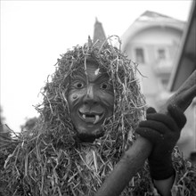 Masked man with pointed teeth and a suit made of straw