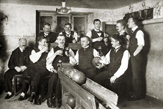 Men in sociable bowling and drinking beer