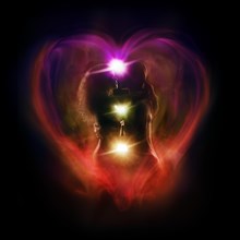 Tantra and Tantric sexuality spiritual concept of a couple making love with the colorful chakra energy flow glowing emanations in a shape of a heart around their bodies. Isolated on black background