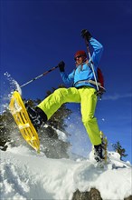 Snowshoe walker with big steps in the snow