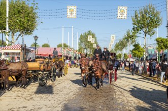 Adorned horse-drawn carriage in front of Casetas