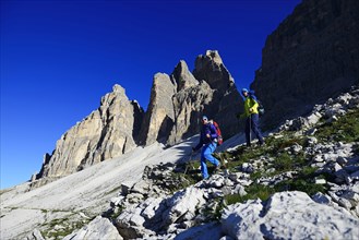 Hikers on the south side of the Three peaks of Lavaredo on the way from the Auronzo hut to the Bullele Joch hut