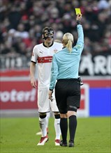 Referee Bibiana Steinhaus shows Christian Gentner of VfB Stuttgart with face mask the yellow card