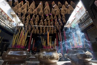 Smoke sacrifice with incense sticks and incense spirals
