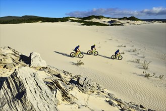 Mountain bikers on sand dunes