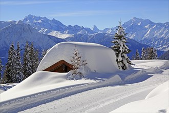 Deeply snow-covered mountain hut
