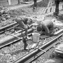 Construction workers laying tracks