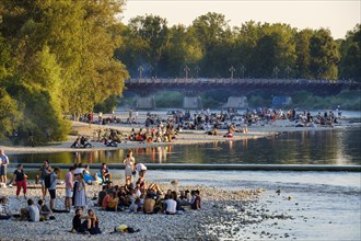 Teenagers on gravel bank at the riverside